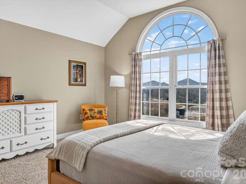 65 Lawson Ridge Road, Leicester, NC 28748.  MLS# CAR4352526, YatesRealty ID 18460. Primary bedroom arched window