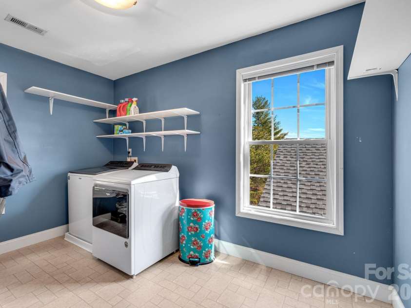 65 Lawson Ridge Road, Leicester, NC 28748.  MLS# CAR4352526, YatesRealty ID 18460. Upper Level Laundry room storage shelving