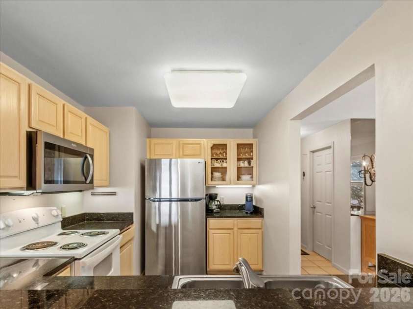 19 Lookout Loop, Burnsville, NC 28714.  MLS# CAR4361238, YatesRealty ID 18471. VIEW OF KITCHEN FROM BRKFST BAR
