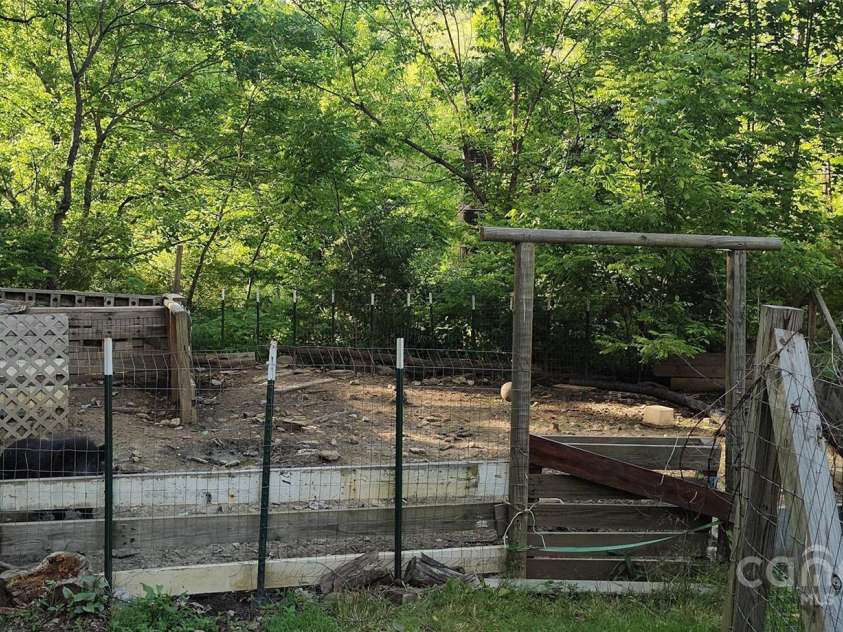 7881 US 25/70 Highway, Marshall, NC 28753.  MLS# CAR4257873, YatesRealty ID 18474. Animal pen currently used as a pig pen