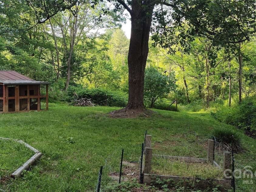 7881 US 25/70 Highway, Marshall, NC 28753.  MLS# CAR4257873, YatesRealty ID 18474. Side yard view