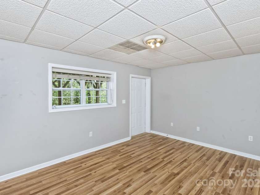 689 New Haw Creek Road, Asheville, NC 28805.  MLS# CAR4251121, YatesRealty ID 18491. 4th bedroom - lower level with access to covered back porch
