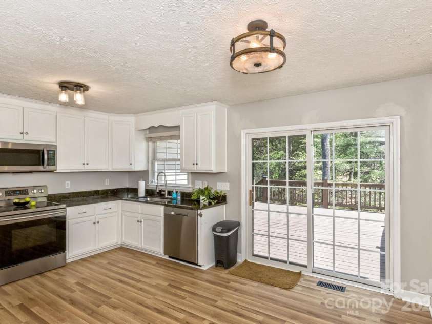 689 New Haw Creek Road, Asheville, NC 28805.  MLS# CAR4251121, YatesRealty ID 18491. Kitchen overlooking large back deck. Space for an island.