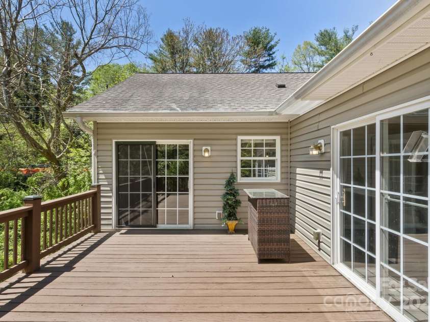 689 New Haw Creek Road, Asheville, NC 28805.  MLS# CAR4251121, YatesRealty ID 18491. Large back porch with access to the kitchen and primary bedroom