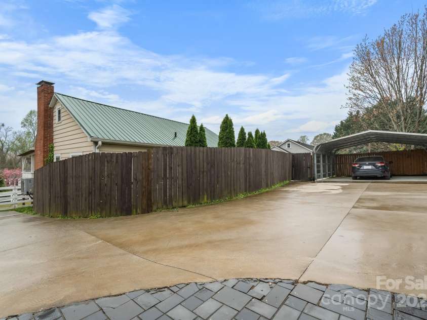 591 Oak Street, Marion, NC 28752.  MLS# CAR4253110, YatesRealty ID 18506. Driveway with 2-Car Carport.