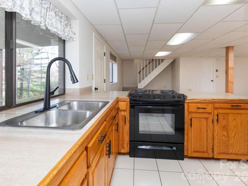 84 Joe jenkins Road, Fairview, NC 28730.  MLS# CAR4320581, YatesRealty ID 18509. Downstairs Kitchen