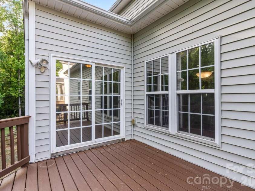 10211 Rivendell Lane, Charlotte, NC 28269.  MLS# CAR4376096, YatesRealty ID 18518. Deck off the Sunroom