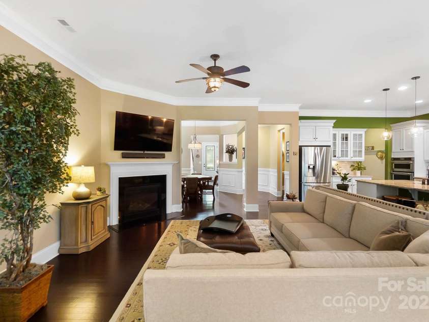 9735 Wheatfield Road, Charlotte, NC 28277.  MLS# CAR4253750, YatesRealty ID 18527. Living room with gas burning fire place and crown moldings