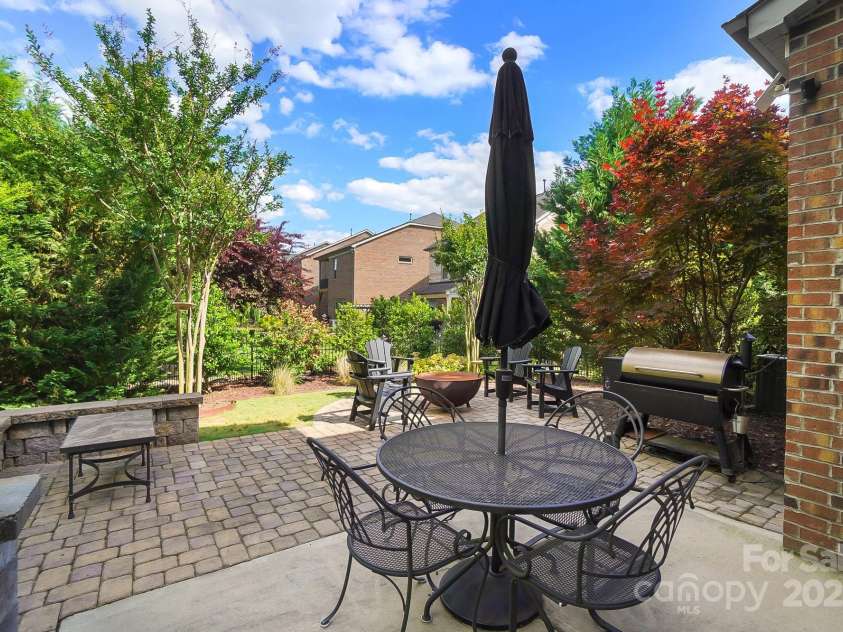 9735 Wheatfield Road, Charlotte, NC 28277.  MLS# CAR4253750, YatesRealty ID 18527. Rear yard custom patio with fire pit area and custom grill area