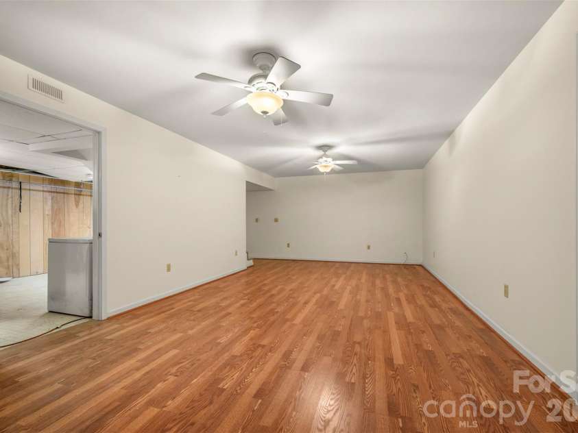 176 Fox Run Lane, Tryon, NC 28782.  MLS# CAR4359459, YatesRealty ID 18539. Basement recreation room