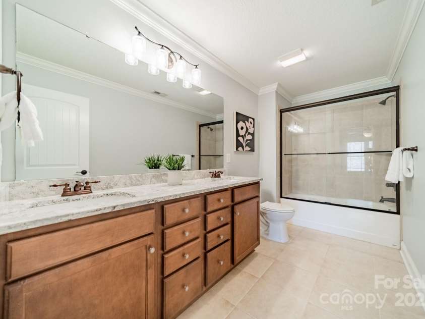 165 Blue Ridge Trail, Mooresville, NC 28117.  MLS# CAR4225294, YatesRealty ID 18540. Ensuite bath in bedroom 2 with dual sinks, full shower and bath, new quartz counters and lighting.