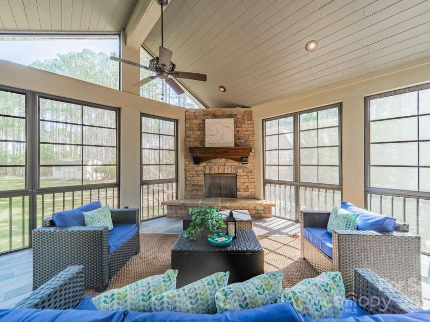 165 Blue Ridge Trail, Mooresville, NC 28117.  MLS# CAR4225294, YatesRealty ID 18540. EZ Breeze porch with gas fireplace, vaulted ceilings, and 2 fans for year round enjoyment.