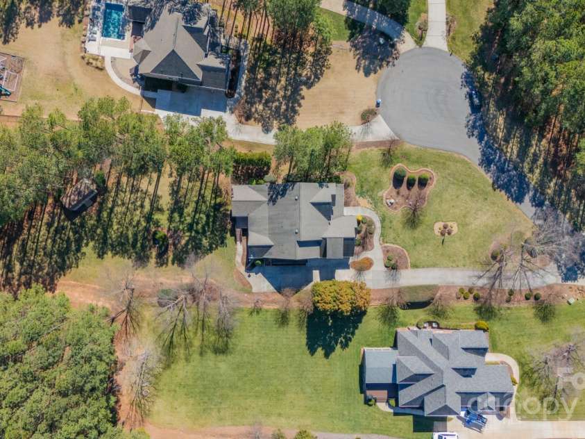 165 Blue Ridge Trail, Mooresville, NC 28117.  MLS# CAR4225294, YatesRealty ID 18540. Overhead of the home, the back yard is deep and extends far past the treeline. Note- this photo is shadowed and the trees are located behind the shed in the far right corner, the backyard is cleared and flat, except