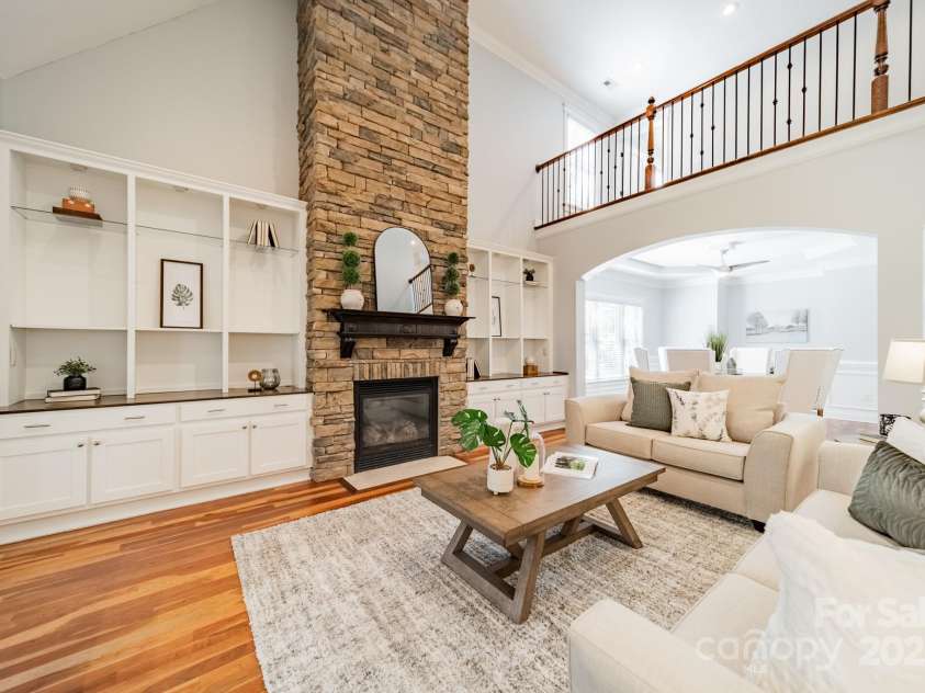 165 Blue Ridge Trail, Mooresville, NC 28117.  MLS# CAR4225294, YatesRealty ID 18540. Two story great room with built in shelving and cabinets as well as a floor to ceiling stone fireplace.