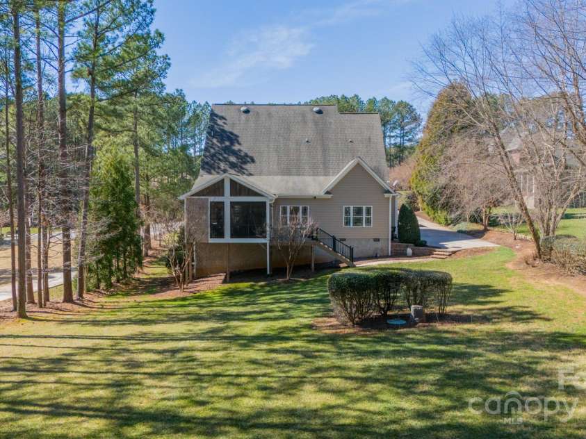 165 Blue Ridge Trail, Mooresville, NC 28117.  MLS# CAR4225294, YatesRealty ID 18540. View of the house from 3/4 of the backyard, standing in front of the shed.