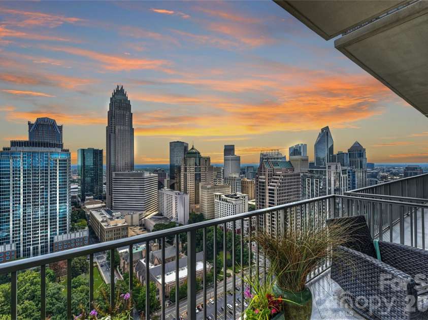 215 Pine Street, Charlotte, NC 28202.  MLS# CAR4186939, YatesRealty ID 18554. Charlotte's skyline at sunset from primary bedroom terrace. 