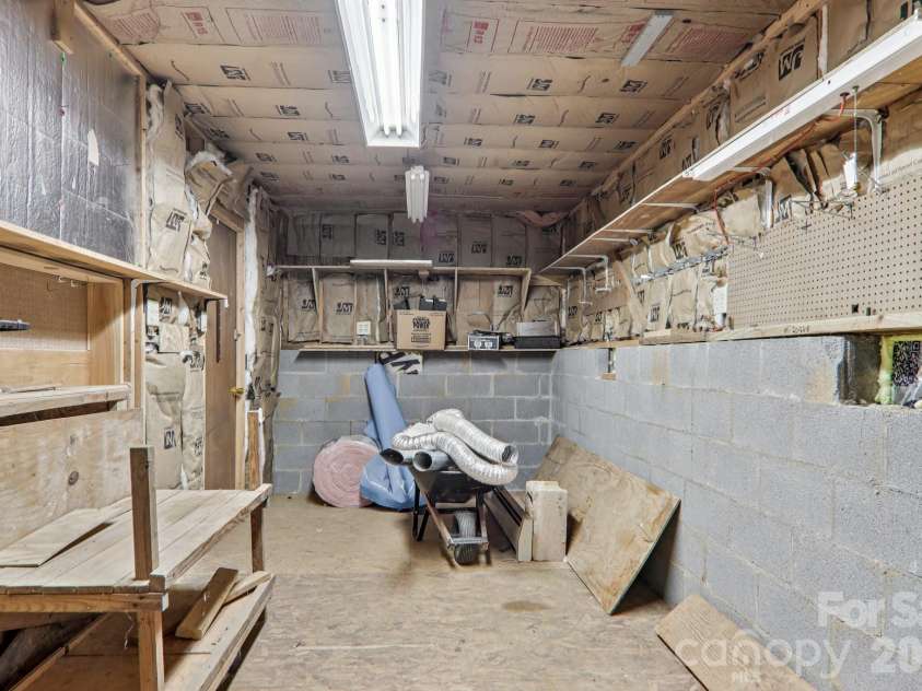 702 Cinnamon Way, Flat Rock, NC 28731.  MLS# CAR4373654, YatesRealty ID 18560. Storage room in crawl space