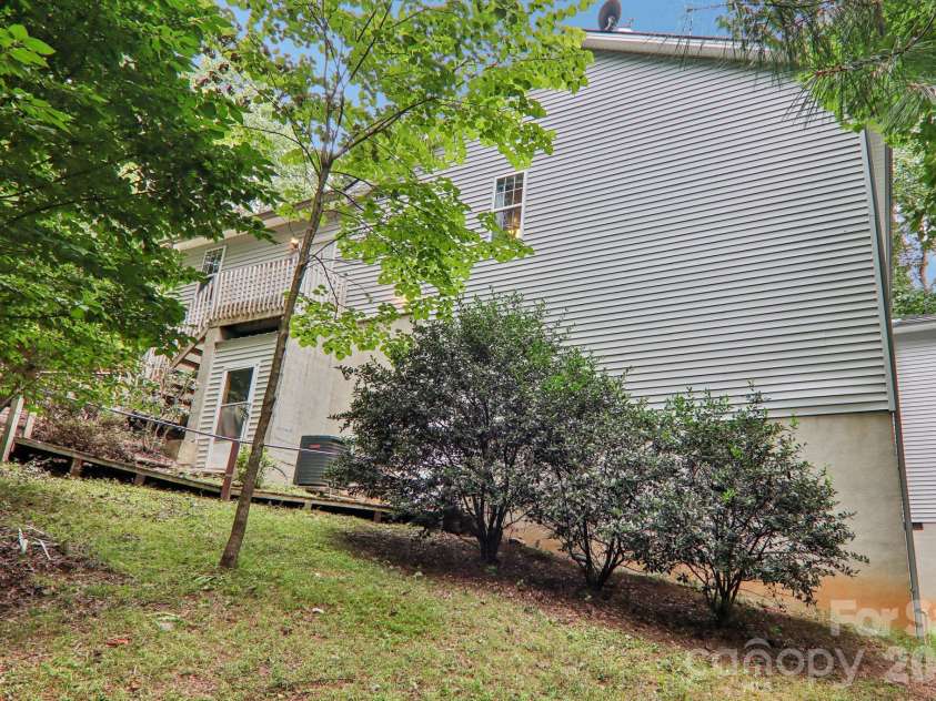 702 Cinnamon Way, Flat Rock, NC 28731.  MLS# CAR4373654, YatesRealty ID 18560. View from side yard