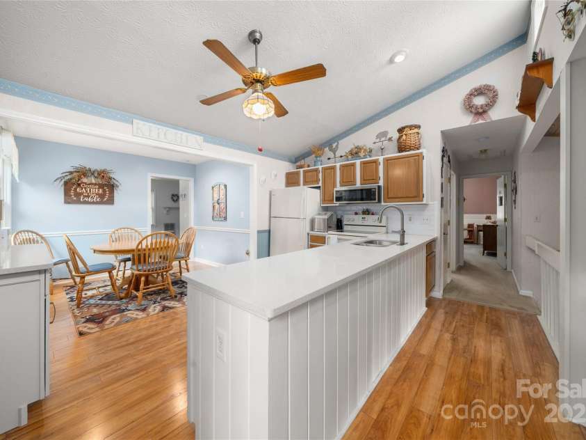 131 Apple Blossom Lane, Maggie Valley, NC 28751.  MLS# CAR4265861, YatesRealty ID 18577. Coffee Bar to the left - dining in the center and large kitchen to the right