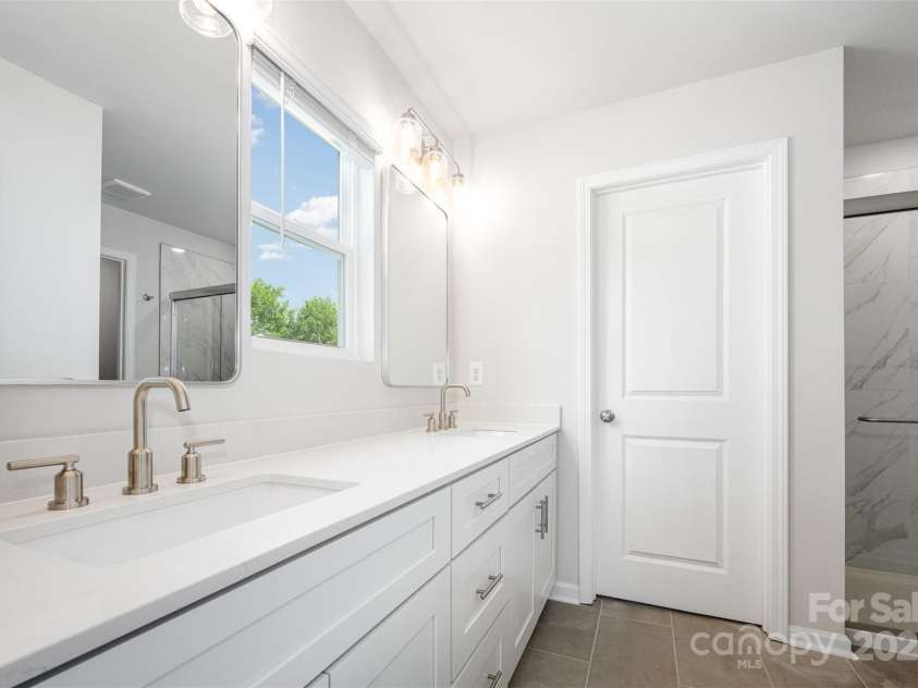 3001 Sadler Woods Lane, Charlotte, NC 28214.  MLS# CAR4272760, YatesRealty ID 1858. Primary bathroom w/double vanity. Representational Photo.