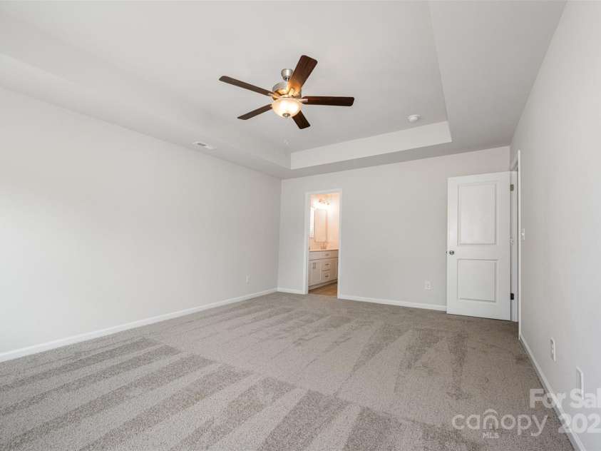 3001 Sadler Woods Lane, Charlotte, NC 28214.  MLS# CAR4272760, YatesRealty ID 1858. Primary bedroom w/ ceiling fan.