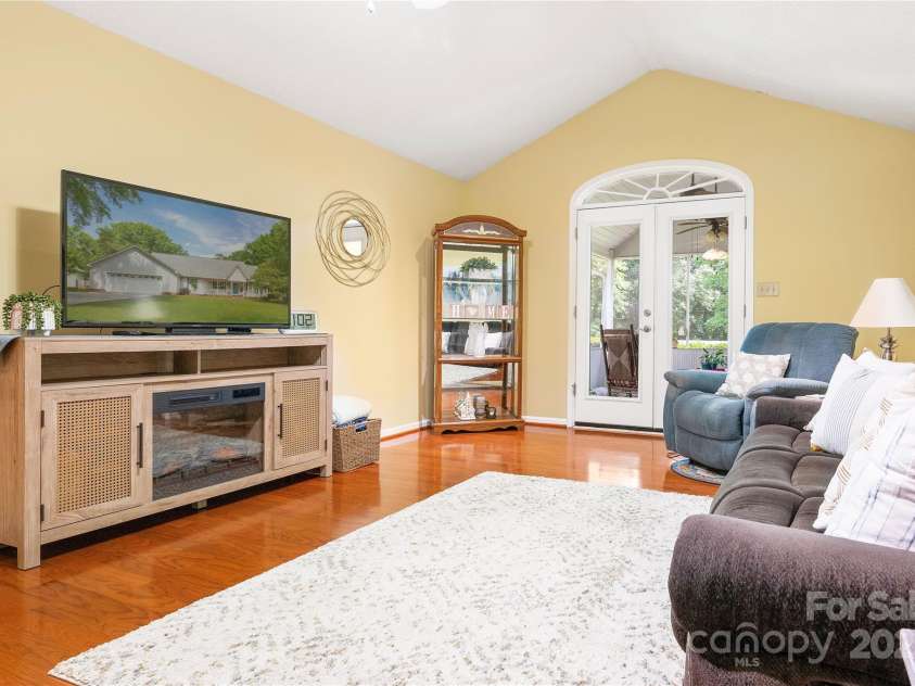 1666 Sam Smith Road, Fort Mill, SC 29708.  MLS# CAR4250464, YatesRealty ID 18586. Living Room leads to screened porch
