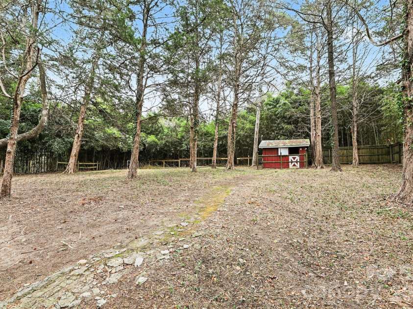 123 Old Bell Road, Charlotte, NC 28270.  MLS# CAR4404093, YatesRealty ID 18610. Large private backyard, which has an incline up to the barn.  Barn area is flat.