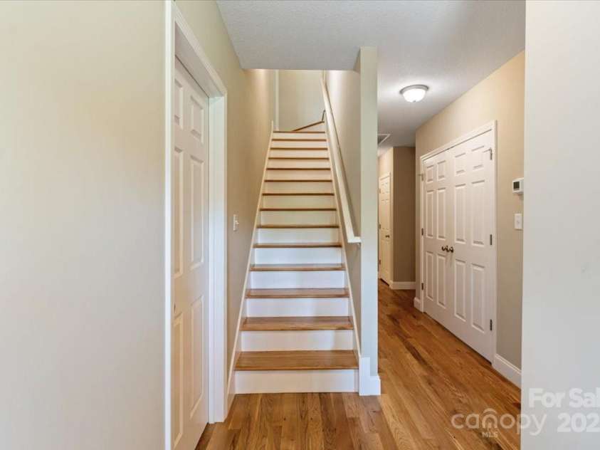 39 Curtis Miles Road, Alexander, NC 28701.  MLS# CAR4266171, YatesRealty ID 18633. Wood Stairs downstairs hall