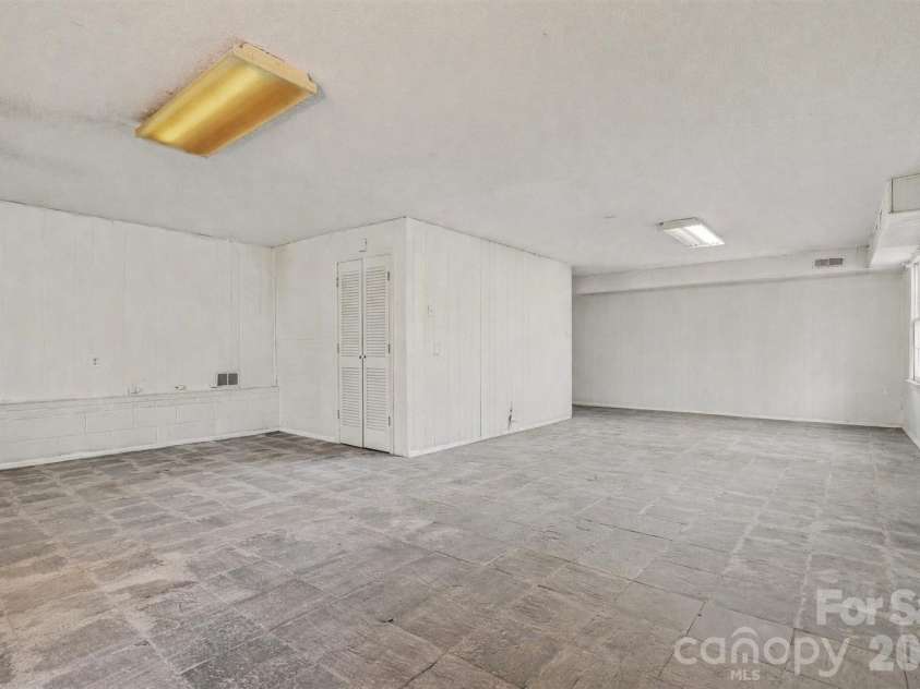 7144 CHAPPARALL Lane, Charlotte, NC 28215.  MLS# CAR4335752, YatesRealty ID 18633. Expansive finished basement space cleaned and staged to showcase its versatility and open layout. Featuring durable flooring, neutral wall tones, and ample lighting, this lower-level area is ideal for recreation, home