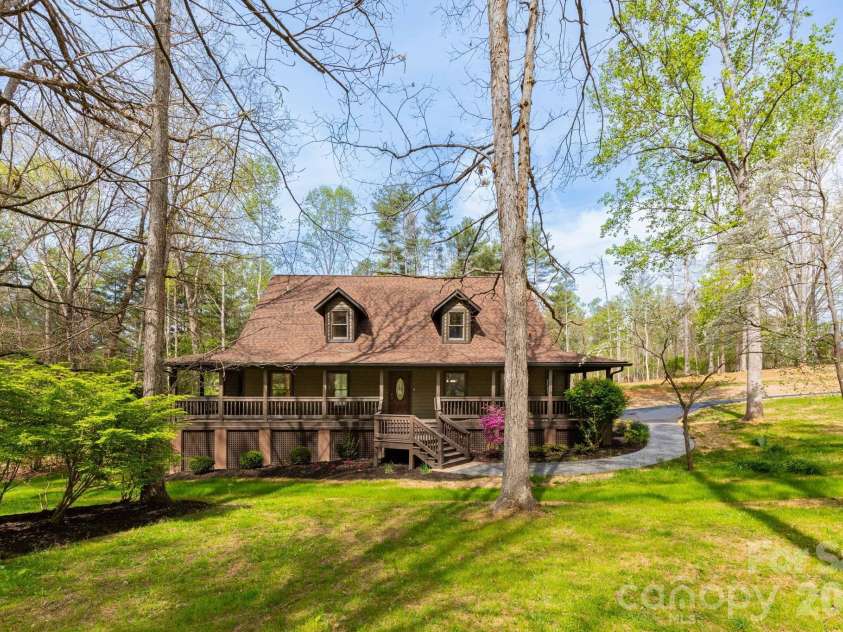 68 Sigmon Road, Fletcher, NC 28732.  MLS# CAR4336800, YatesRealty ID 18650. Beautiful front elevation with classic architecture, mature trees, and a peaceful, park-like yard offering both privacy and curb appeal.