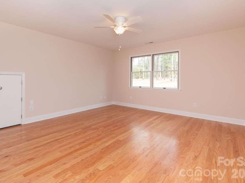 68 Sigmon Road, Fletcher, NC 28732.  MLS# CAR4336800, YatesRealty ID 18650. Bright and airy bedroom with hardwood floors and natural light—ideal for a home office, playroom, or additional living space.