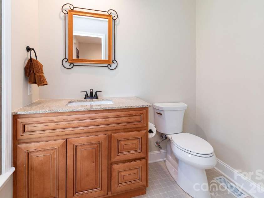 68 Sigmon Road, Fletcher, NC 28732.  MLS# CAR4336800, YatesRealty ID 18650. Charming half bath with updated vanity and neutral finishes.