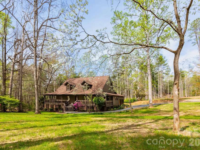 68 Sigmon Road, Fletcher, NC 28732.  MLS# CAR4336800, YatesRealty ID 18650. Charming mountain retreat nestled on a private, wooded setting with a welcoming wraparound porch—perfect for relaxing and enjoying nature.