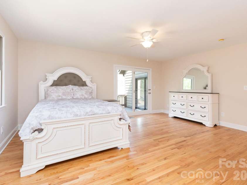 68 Sigmon Road, Fletcher, NC 28732.  MLS# CAR4336800, YatesRealty ID 18650. Expansive primary suite offering ample space for furnishings and a private retreat feel with access to outdoor living.