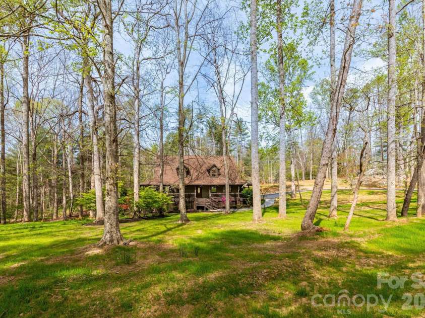 68 Sigmon Road, Fletcher, NC 28732.  MLS# CAR4336800, YatesRealty ID 18650. Expansive yard surrounded by towering hardwoods, creating a serene and private setting with room to garden or play.