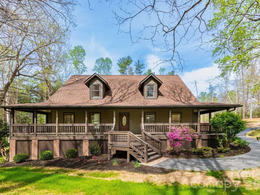 68 Sigmon Road, Fletcher, NC 28732.  MLS# CAR4336800, YatesRealty ID 18650. Inviting front porch entry with plenty of space for rocking chairs—ideal for enjoying morning coffee or quiet evenings outdoors.