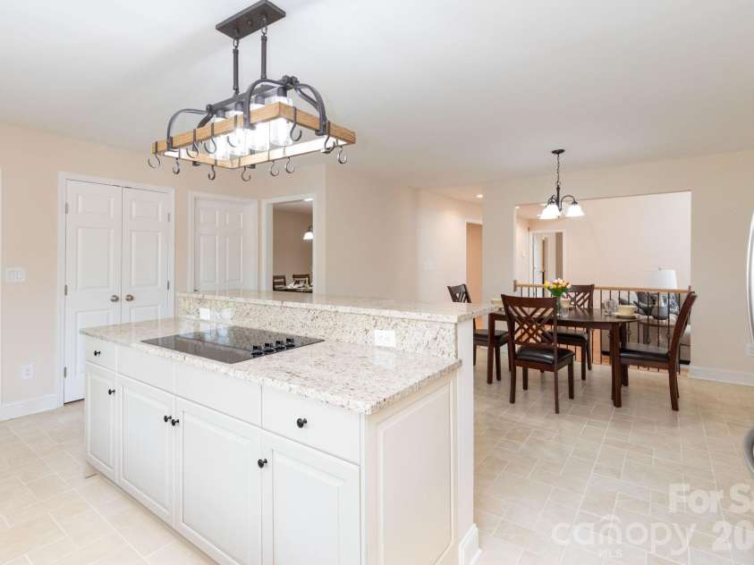 68 Sigmon Road, Fletcher, NC 28732.  MLS# CAR4336800, YatesRealty ID 18650. Kitchen and dining flow seamlessly together, creating a welcoming space for gathering with family and friends.