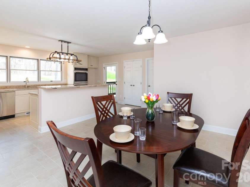 68 Sigmon Road, Fletcher, NC 28732.  MLS# CAR4336800, YatesRealty ID 18650. Open-concept kitchen and eating area featuring granite countertops, ample cabinetry, and a functional layout.