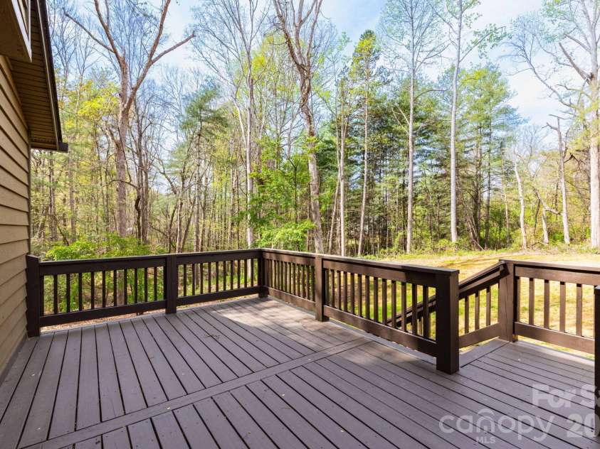 68 Sigmon Road, Fletcher, NC 28732.  MLS# CAR4336800, YatesRealty ID 18650. Private rear deck access with wooded views, creating a peaceful outdoor retreat right off the home.