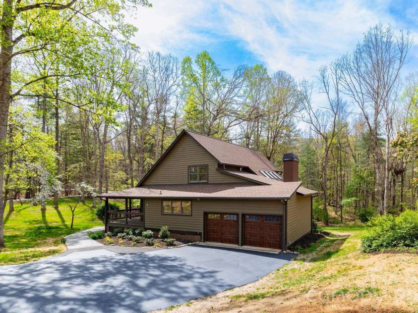 68 Sigmon Road, Fletcher, NC 28732.  MLS# CAR4336800, YatesRealty ID 18650. Rear exterior featuring an oversized two-car garage and paved driveway with easy access and plenty of parking.