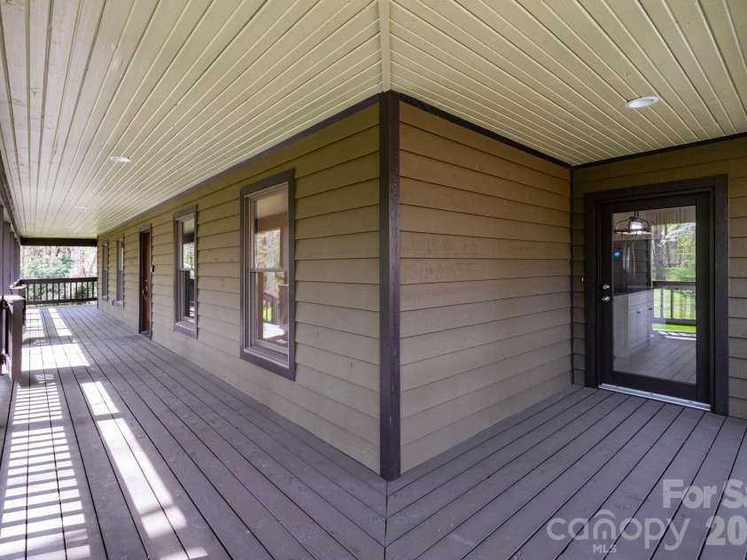 68 Sigmon Road, Fletcher, NC 28732.  MLS# CAR4336800, YatesRealty ID 18650. Spacious covered wraparound porch offering multiple seating areas—perfect for enjoying peaceful outdoor living year-round.