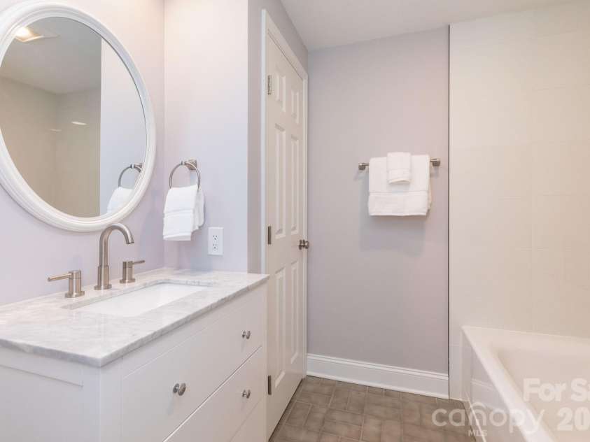 68 Sigmon Road, Fletcher, NC 28732.  MLS# CAR4336800, YatesRealty ID 18650. Stylish full bathroom with modern finishes, clean lines, and a tiled tub/shower combination.