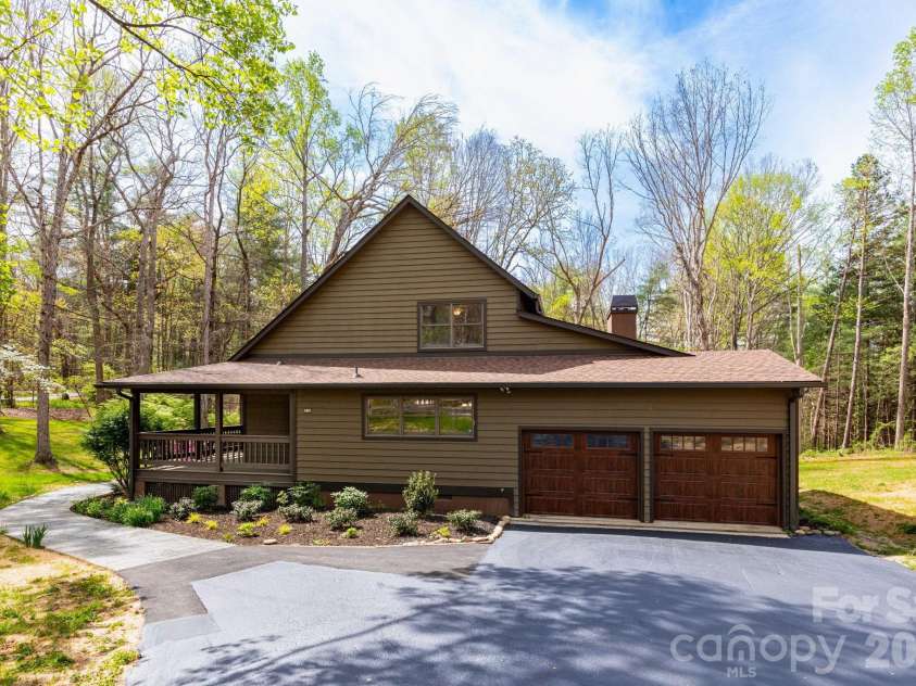 68 Sigmon Road, Fletcher, NC 28732.  MLS# CAR4336800, YatesRealty ID 18650. Wraparound porch continues along the side of the home, offering multiple outdoor living spaces to enjoy every season.