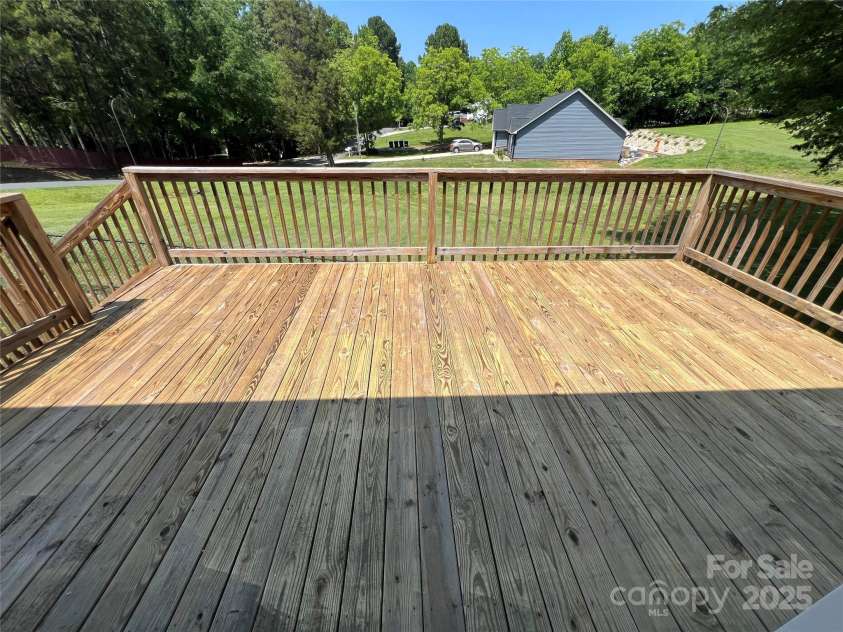 8095 New Street, Mount Pleasant, NC 28124.  MLS# CAR4264803, YatesRealty ID 18650. Nice deck accessed from the carport overlooking the back yard.