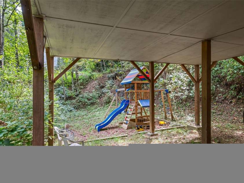 650 Creekside Drive, Maggie Valley, NC 28751.  MLS# CAR4335648, YatesRealty ID 18657. Flat outdoor space with covered area would lend itself well to an outdoor wellness area with covered patio, hot tub, plunge pool and/or sauna