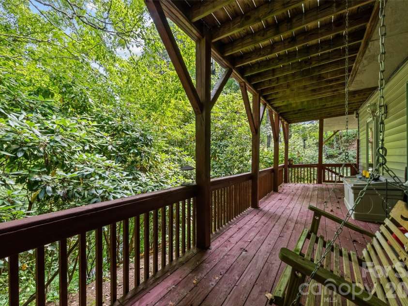 650 Creekside Drive, Maggie Valley, NC 28751.  MLS# CAR4335648, YatesRealty ID 18657. Lower Deck provides shaded seclusion and a place to swing your cares away.