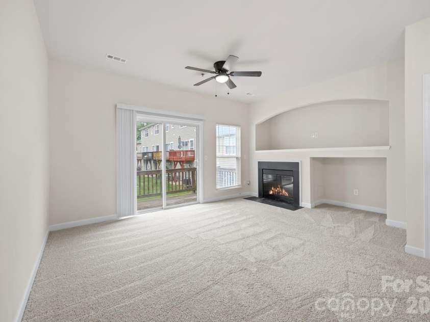 2750 Avalon Loop Road, Charlotte, NC 28269.  MLS# CAR4376282, YatesRealty ID 18660. Another view of family room with fireplace 