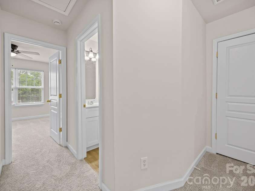 2750 Avalon Loop Road, Charlotte, NC 28269.  MLS# CAR4376282, YatesRealty ID 18660. Hall way on upper level, seeing full bath entrya nd owners suite, linen/storage closet to the right.