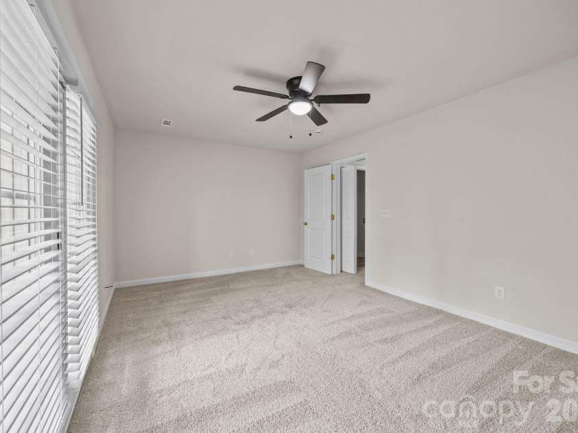 2750 Avalon Loop Road, Charlotte, NC 28269.  MLS# CAR4376282, YatesRealty ID 18660. Lower level is large enough for multiple ideas, doors to patio, new carpet, ceiling fan too.   