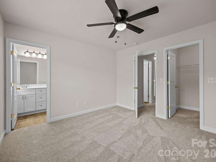 2750 Avalon Loop Road, Charlotte, NC 28269.  MLS# CAR4376282, YatesRealty ID 18660. Owners suite, looking toward hall and view of walk in closet and ensuite bathroom entrance.
